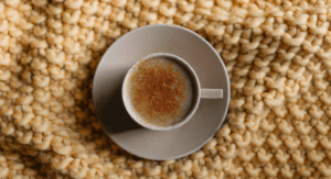Coffee cup on kintted blanket